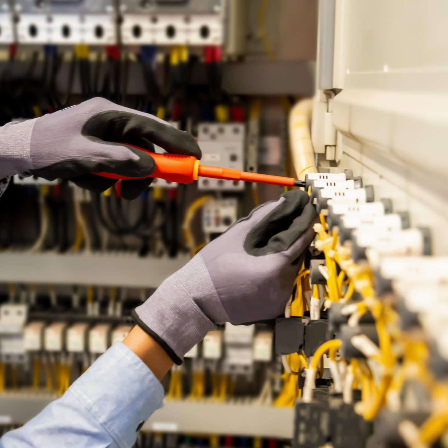 Electricians work to connect electric wires in the system, switchboard, electrical system in Control cabinet.